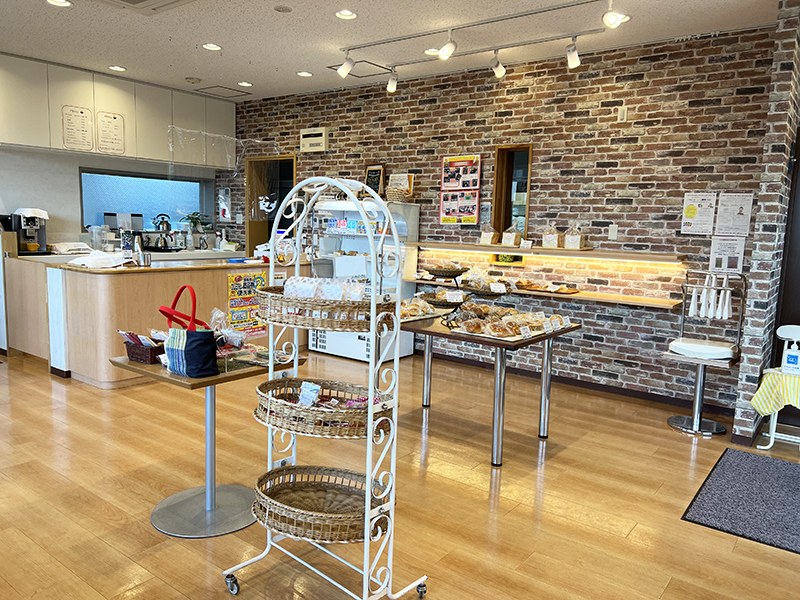 パンが並ぶショーケースとカウンター、れんが調の壁の店内