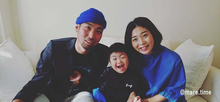 白いソファーに並んで座り、笑顔を見せる佐々木さん一家の3人